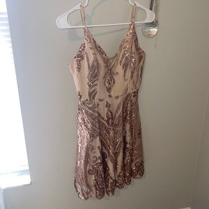 Pink and rose gold cocktail dress, hits above the knee and has adjustable straps